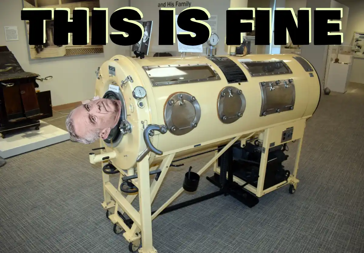 A man's head is digitally pasted into the opening of a vintage, beige, cylindrical iron lung on display in a museum. The…