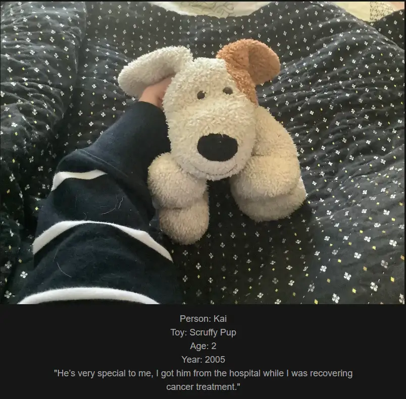 A person's arm in a dark blue and white striped sleeve holds a fluffy, light-colored stuffed dog toy with a brown patch on…