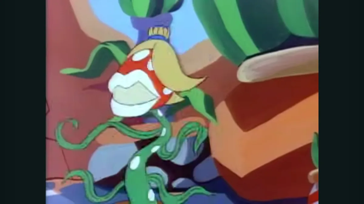 A cartoon character with a red face, white teeth, and green tentacles is shown with a wide, toothy grin. The character has…