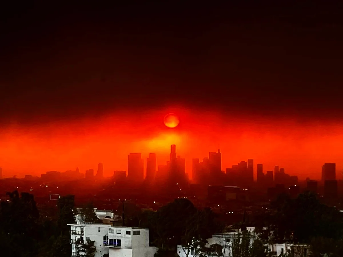 a dramatic, apocalyptic-style photo of a city skyline under a blood-red sky with a glowing orange sun, overlaid with the…