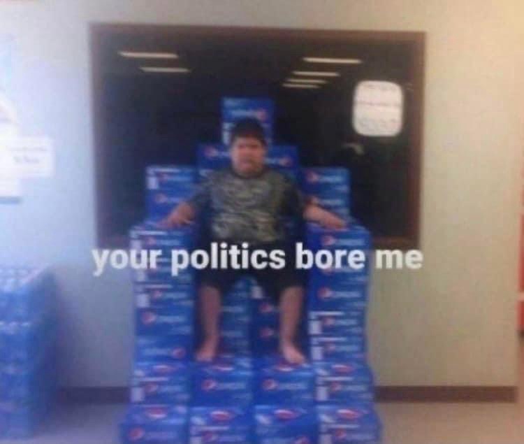 A person sits barefoot on a throne-like structure made of stacked blue Pepsi product boxes inside what appears to be a…