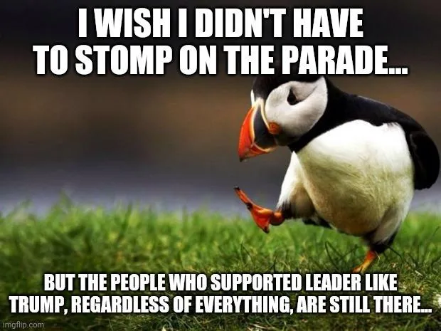 A penguin stands on green grass, lifting one foot as if stomping, with a blurred background. White bold text overlays the…