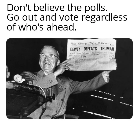 A black-and-white photo of a smiling man in a suit and glasses holding up a newspaper with the headline 'DEWEY DEFEATS…