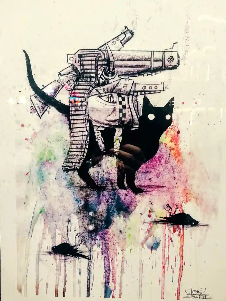 A stylized black cat with white eyes is depicted holding a large, detailed machine gun, with colorful watercolor splatters…