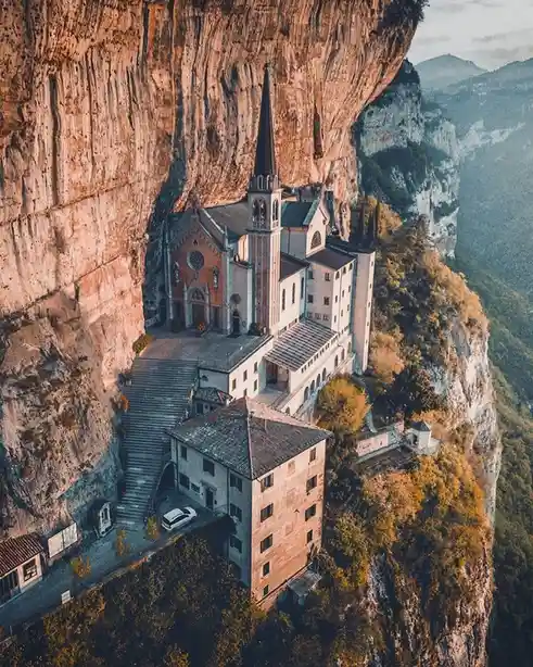A Church Perched on the Edge of a Cliff in Italy