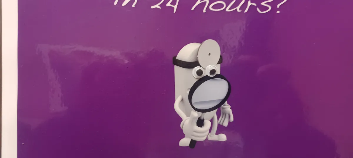A white cartoon character with googly eyes and a magnifying glass holds it up to its face against a purple background. Above…