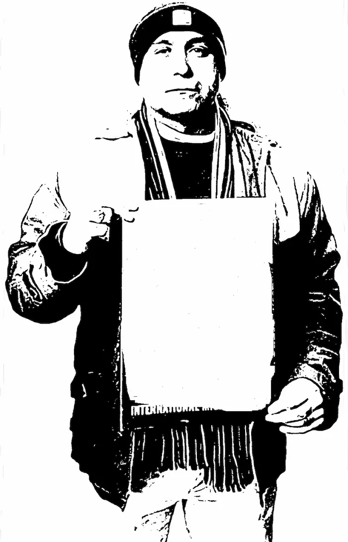 A high-contrast black-and-white image shows a man wearing a beanie, scarf, and jacket, holding a blank white sign. The text…