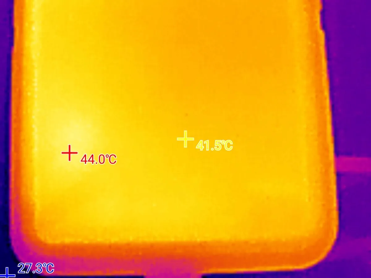 A thermal image of a rectangular electronic device, likely a phone or tablet, showing temperature readings overlaid in red…