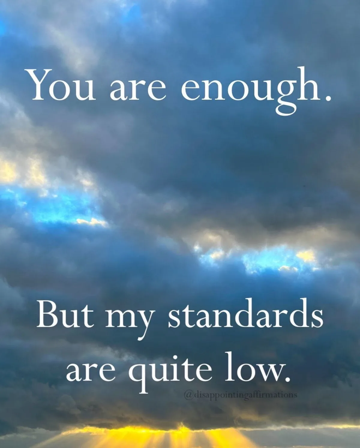 A dramatic sky image with dark clouds and bright sunbeams at the bottom, overlaid with white text reading 'You are enough.'…