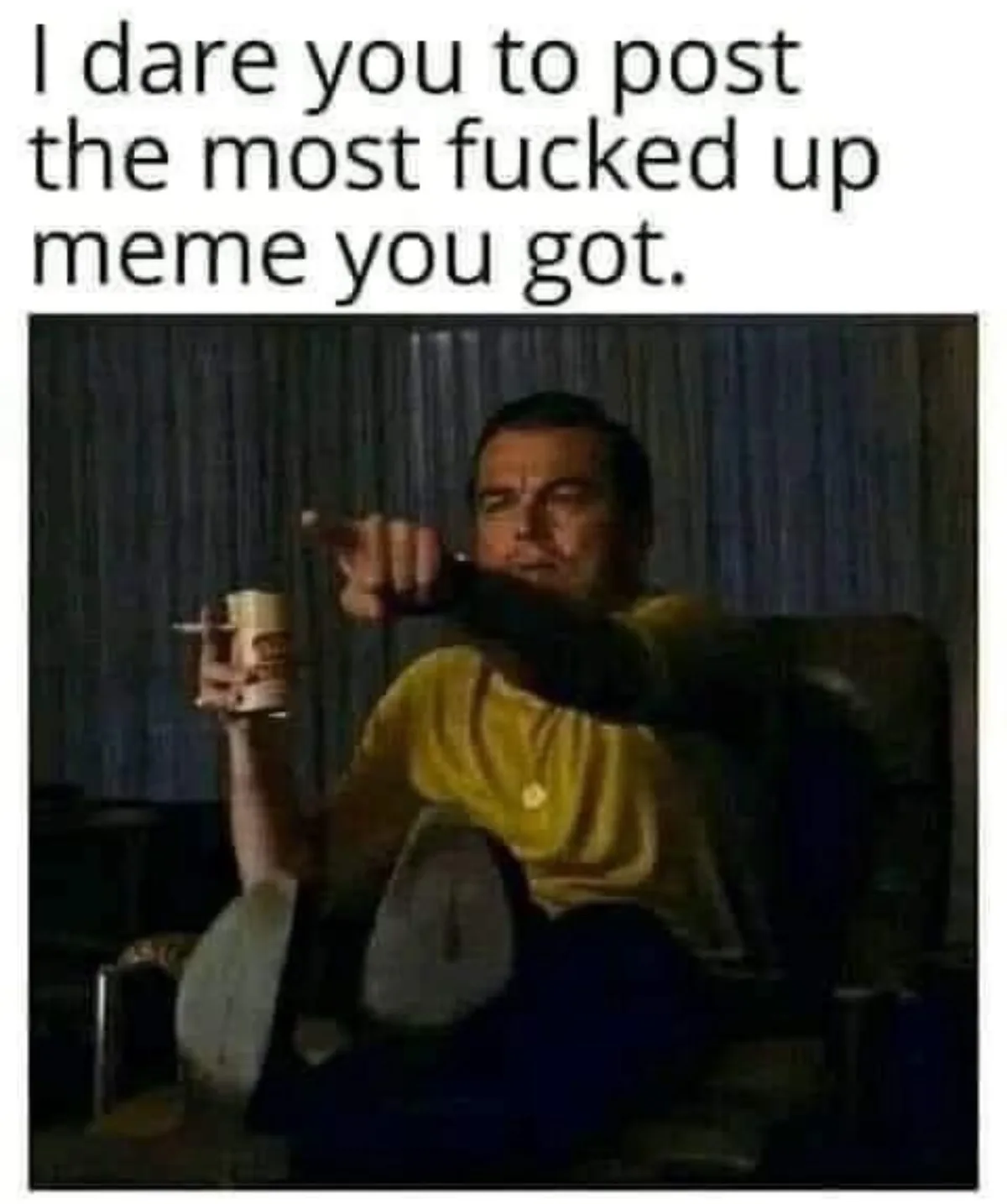 A man in a yellow shirt sits in a dark room, holding a mug in one hand and pointing aggressively with the other. The text…