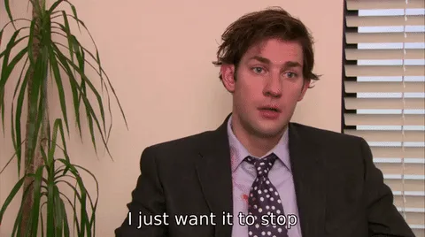 The image shows six identical frames of actor John Krasinski in a suit and tie, seated in an office with a potted plant and…