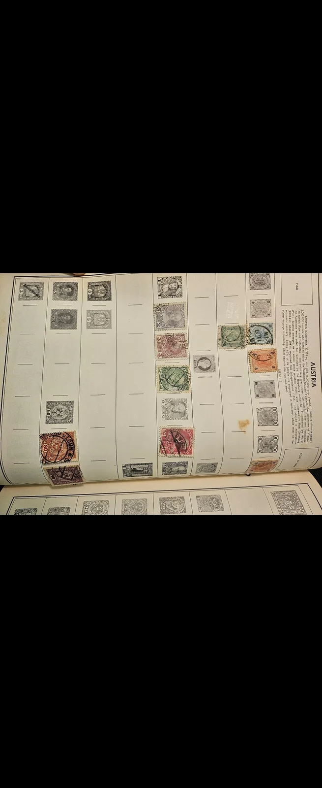 An open stamp album page showing a collection of Austrian postage stamps arranged in rows, with some slots empty and others…