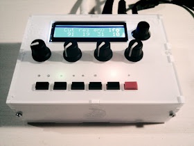 A white electronic device with a digital display showing '40 40 40 40 40' and multiple black knobs and buttons, including a…
