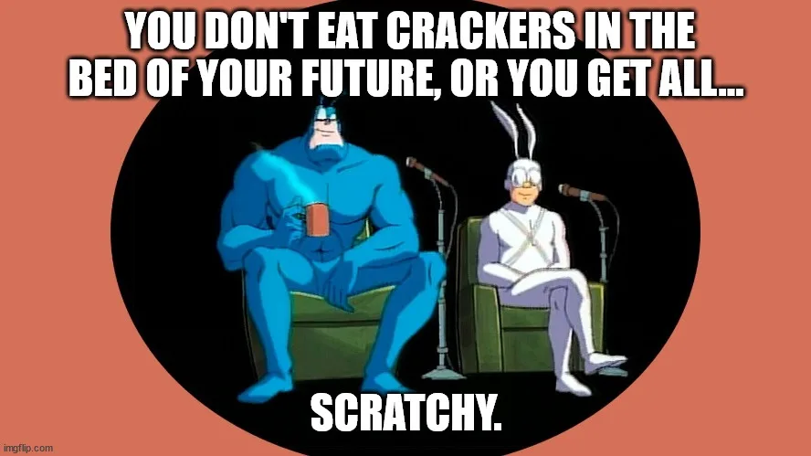 Two animated characters, a blue muscular man holding a mug and a white rabbit-like figure, sit in green armchairs with…