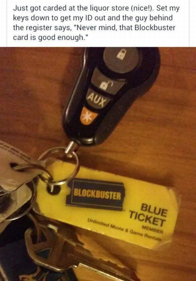 A close-up photo shows a car key fob attached to a keychain with a yellow Blockbuster Blue Ticket member card. The card…