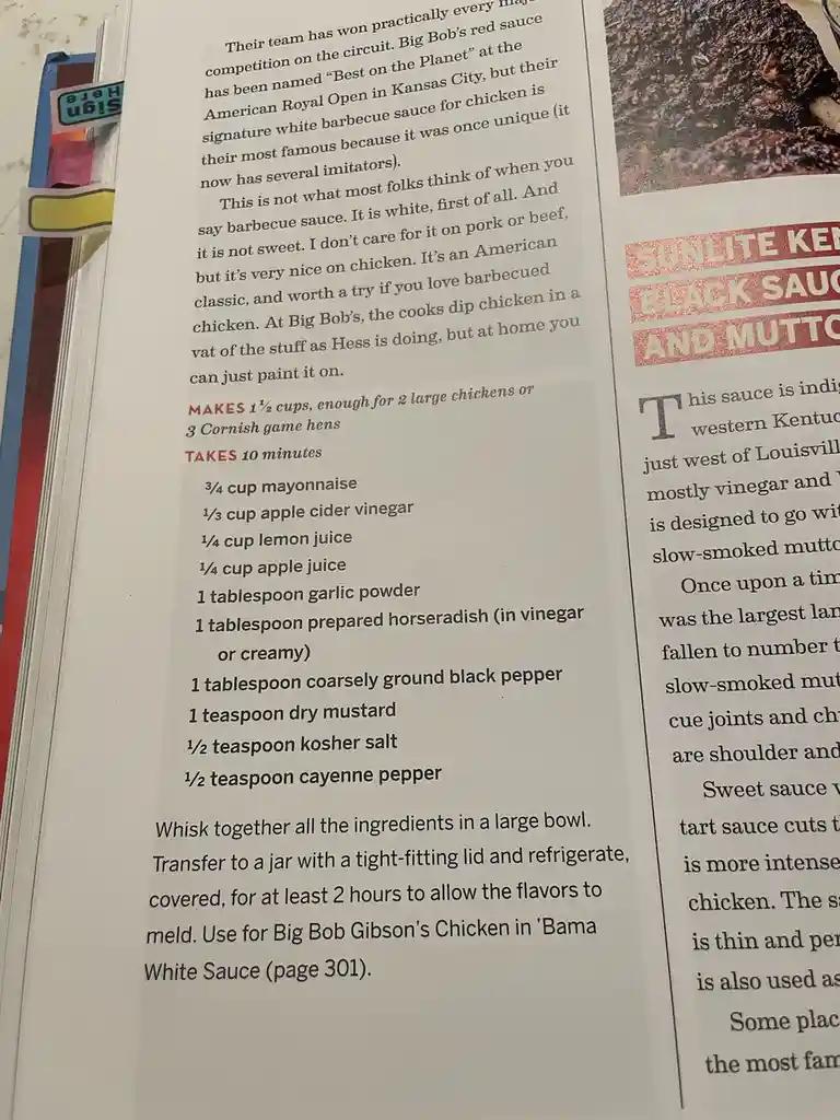 A close-up photo of a cookbook page showing a recipe for 'Big Bob Gibson's Chicken White Sauce,' which is described as…