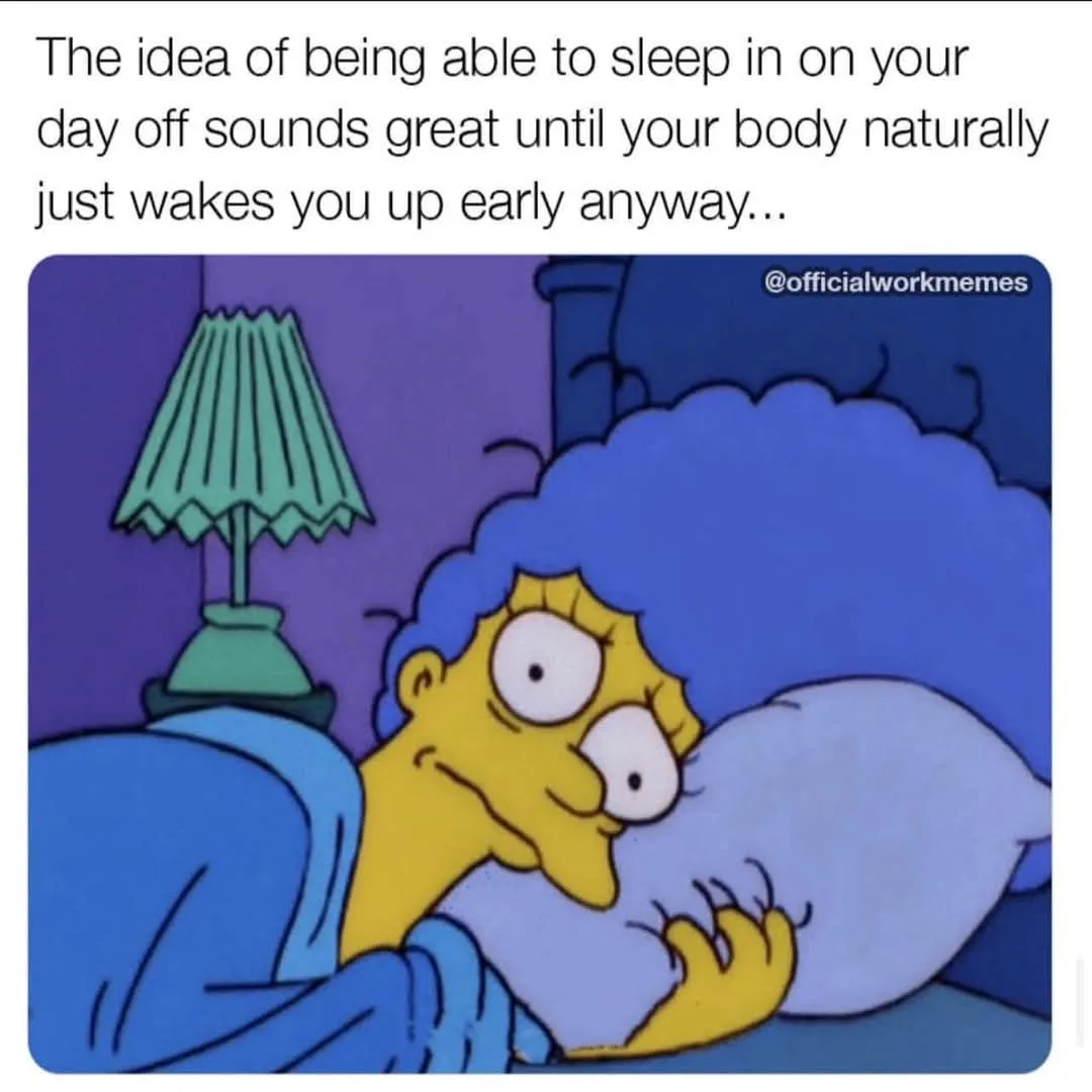 A cartoon image of Marge Simpson in bed, looking annoyed and wide-eyed as she's being woken up. She's clutching a pillow…