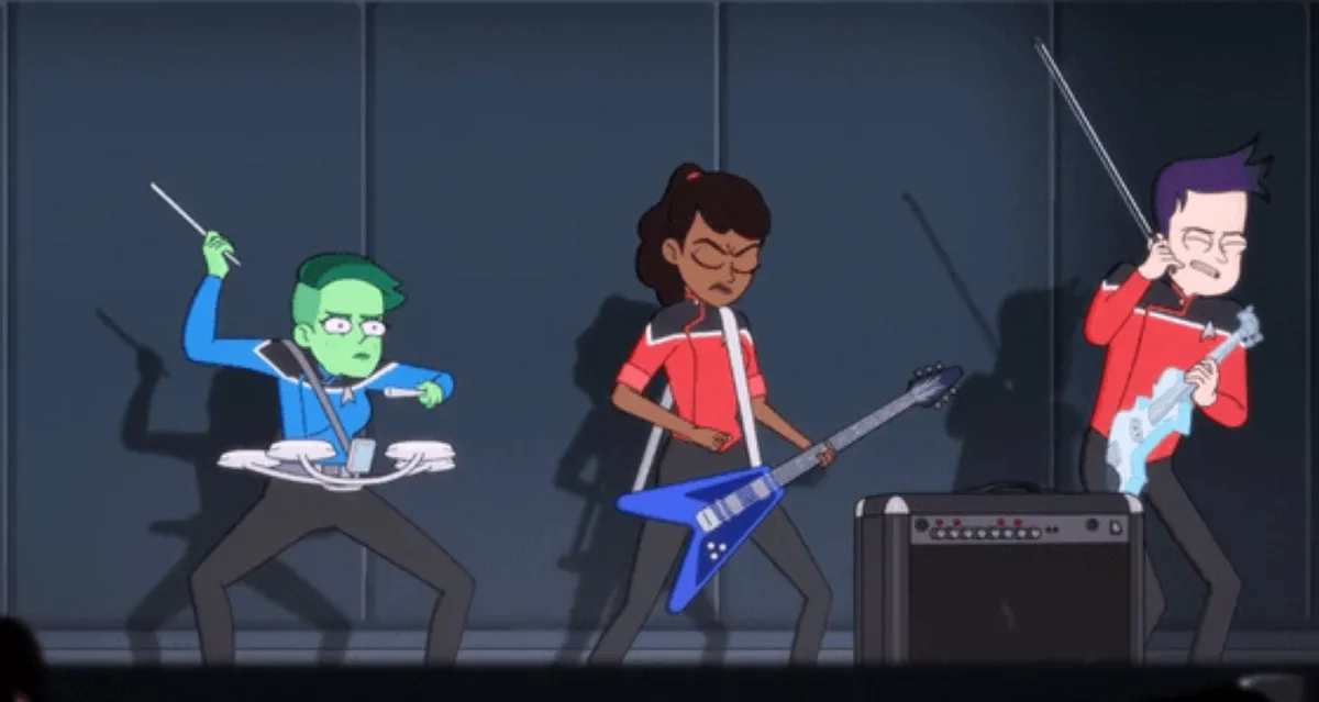 Three animated Starfleet crew members from 'Star Trek: Lower Decks' are performing on stage as a band. The green-skinned…