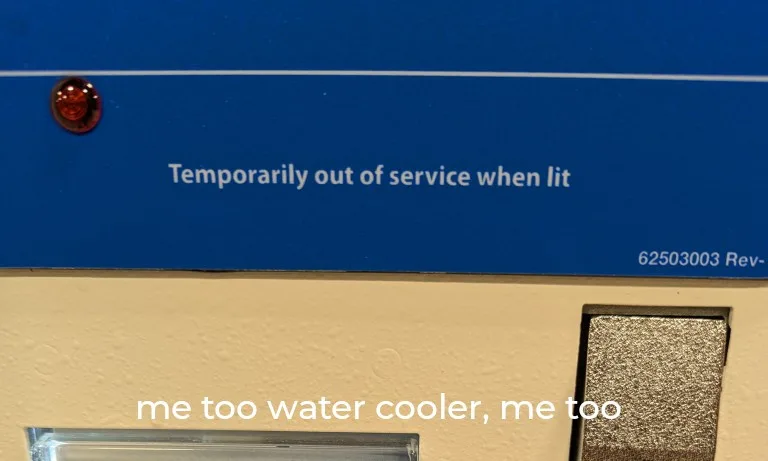 A close-up of a water cooler's blue panel shows a red warning light illuminated, with the printed text 'Temporarily out of…