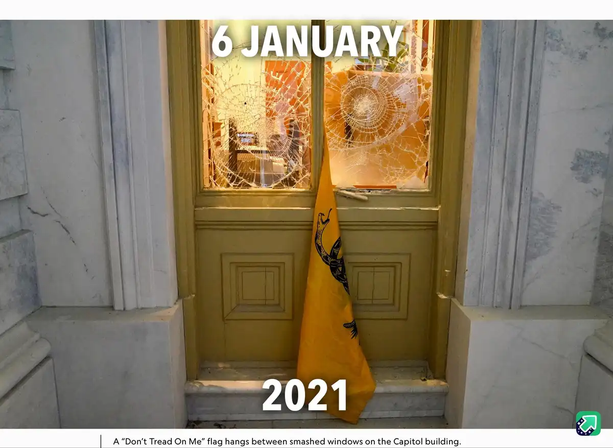 A photograph shows a yellow door with two shattered windows, framed by marble columns. A yellow 'Don't Tread On Me' flag…