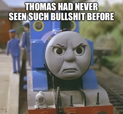 A close-up of Thomas the Tank Engine with a furious, scowling expression, his eyebrows furrowed and mouth downturned. The…