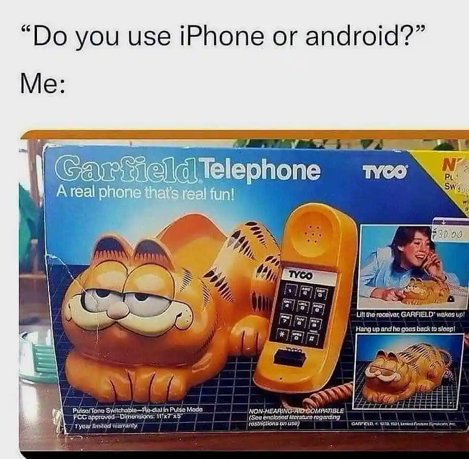 An image of a vintage Garfield telephone toy box, showing a large orange cat-shaped phone that wakes up when lifted and goes…