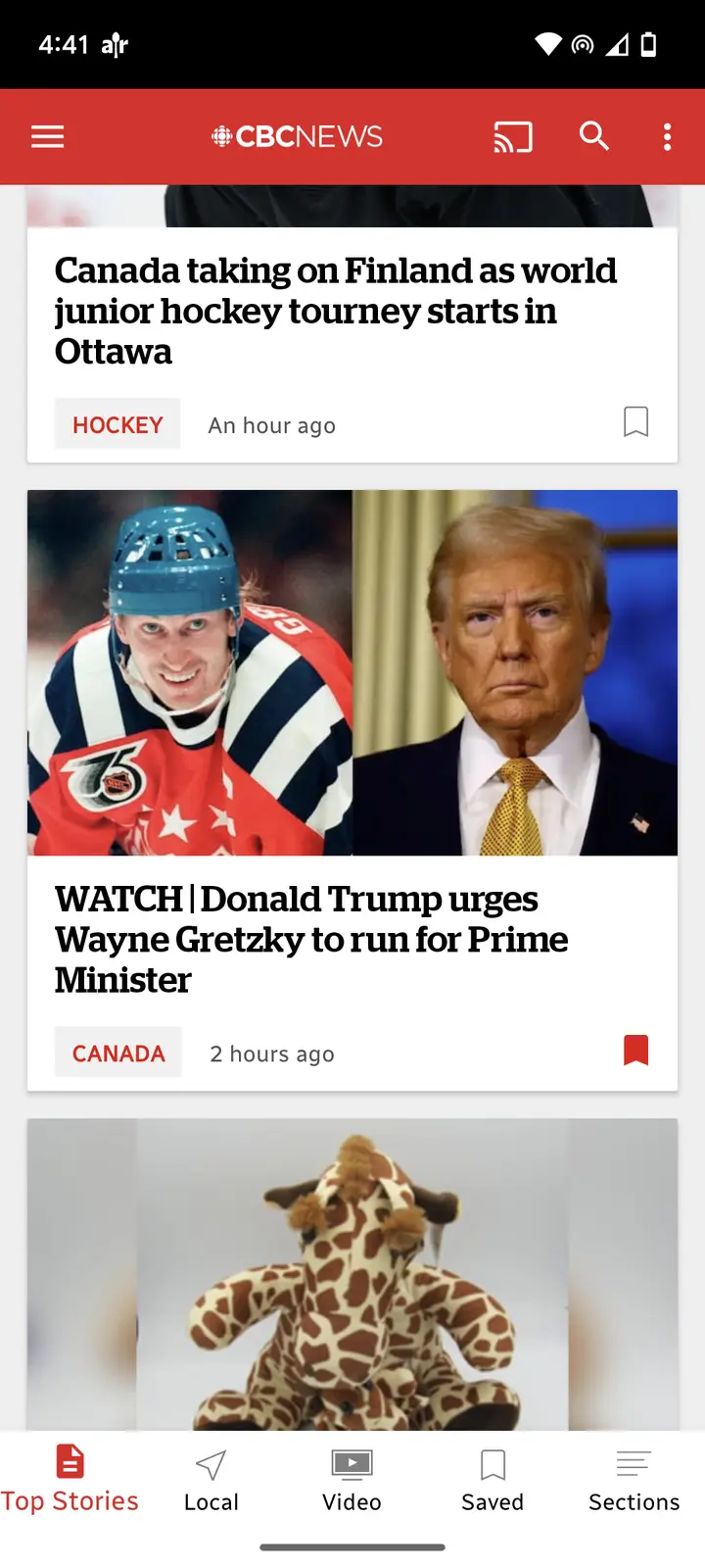A screenshot of the CBC News app shows a headline about Donald Trump urging Wayne Gretzky to run for Prime Minister…