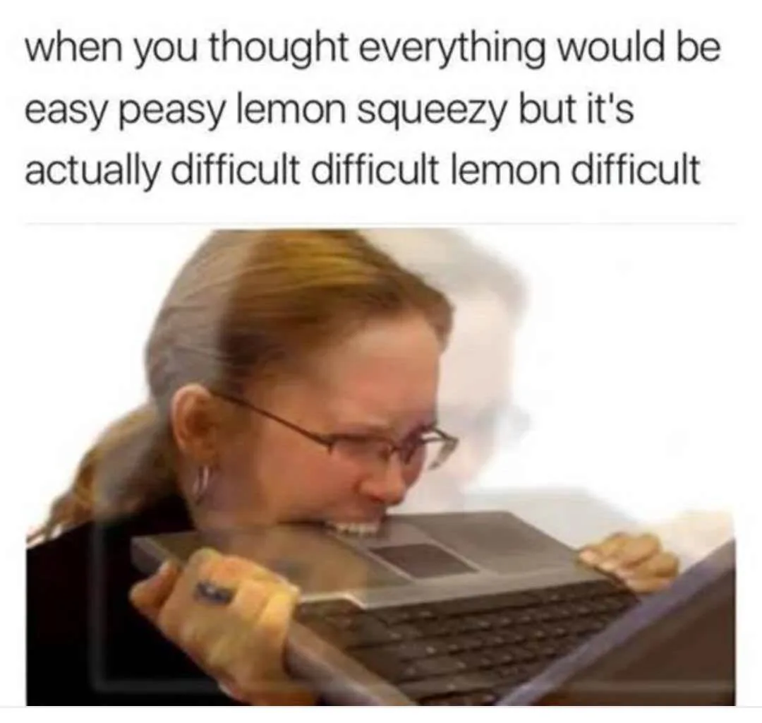 A woman with glasses and her hair in a ponytail is shown biting down hard on the edge of a laptop keyboard, her face…