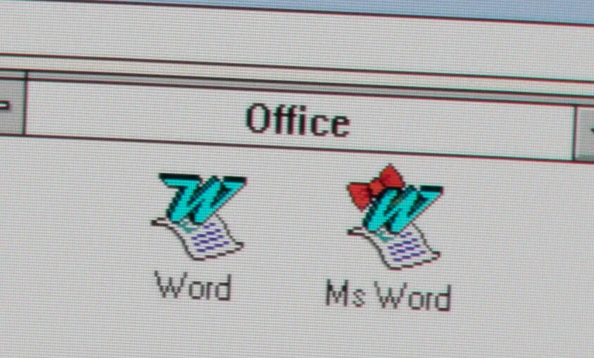 A close-up of an old Windows computer screen showing the 'Office' folder with two icons: 'Word' and 'Ms Word'. The 'Ms Word'…