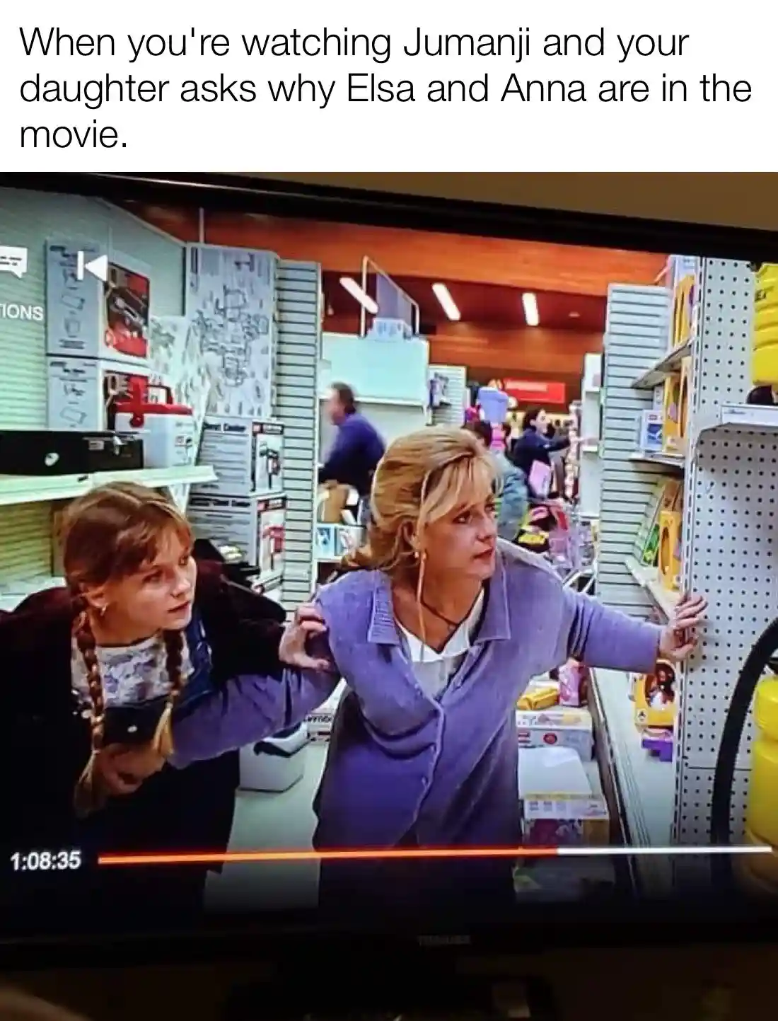 A screenshot of a TV screen showing a scene from the movie Jumanji, where a young girl with braids and a woman in a purple…