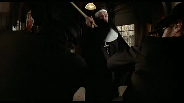 A composite image shows a nun wielding a ruler in a dimly lit room, followed by a man in a fedora and sunglasses reacting…