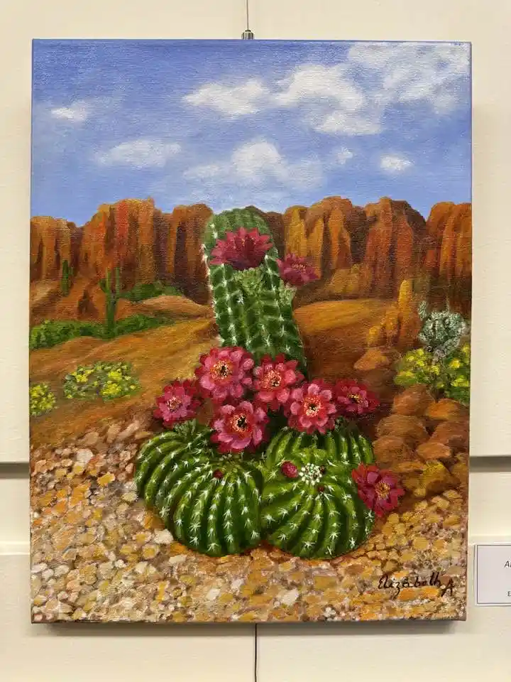 a painting of a desert scene featuring green cacti with vibrant pink flowers, set against a backdrop of orange rock…