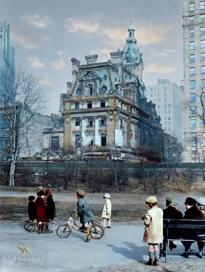 An old colorized photograph shows children playing in a park with a grand, ornate historical building in the background…