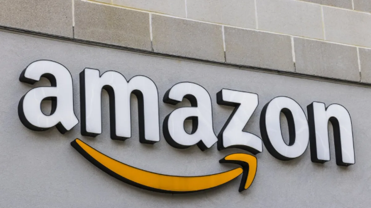 A close-up photograph of the Amazon corporate logo, featuring the word 'amazon' in white lowercase letters with a yellow…