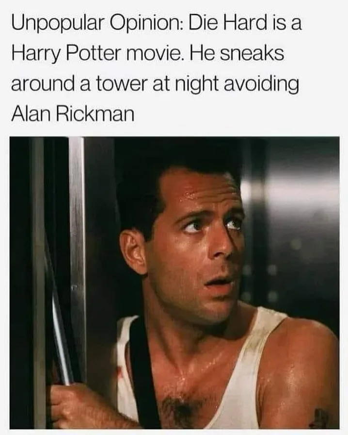 A man in a white tank top and black suspenders, visibly sweaty and holding a metal pole, looks upward with a startled…