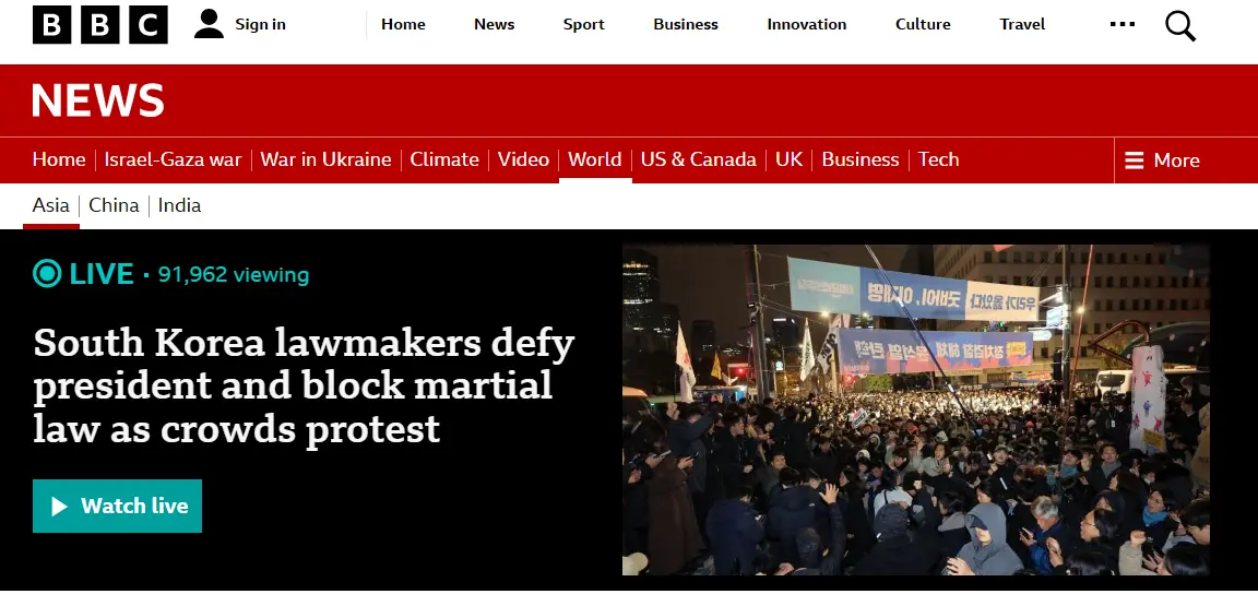 A BBC News webpage screenshot shows a live broadcast headline about South Korean lawmakers blocking martial law during a…
