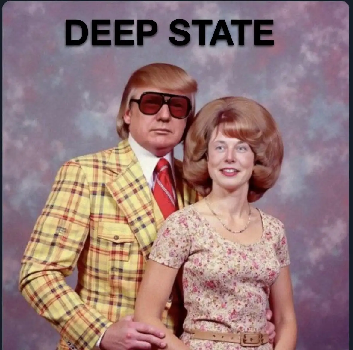 A vintage 1970s-style studio portrait shows a man and woman posing together against a mottled purple and gray backdrop. The…
