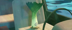 A green, cartoonish leek character with large eyes is shown in a boat, initially looking calm, then progressively widening…