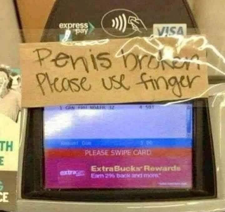 A close-up of a store card reader with a handwritten note taped over the screen. The note reads 'Penis broken Please use…