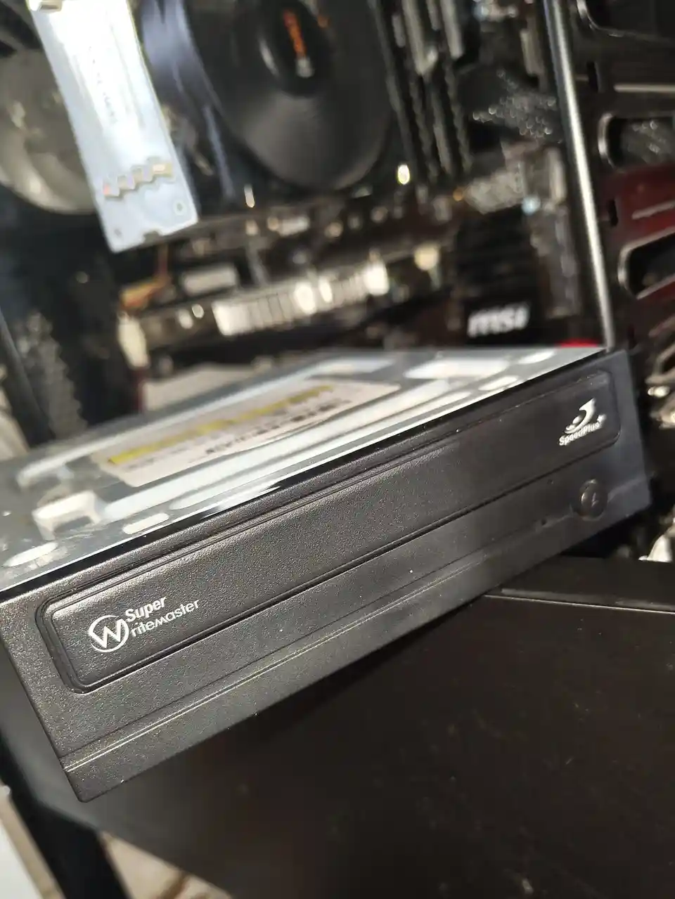 A close-up photo of a black computer power supply unit with the brand name 'Super riteMASTER' and 'SpeedPlus' logos visible…