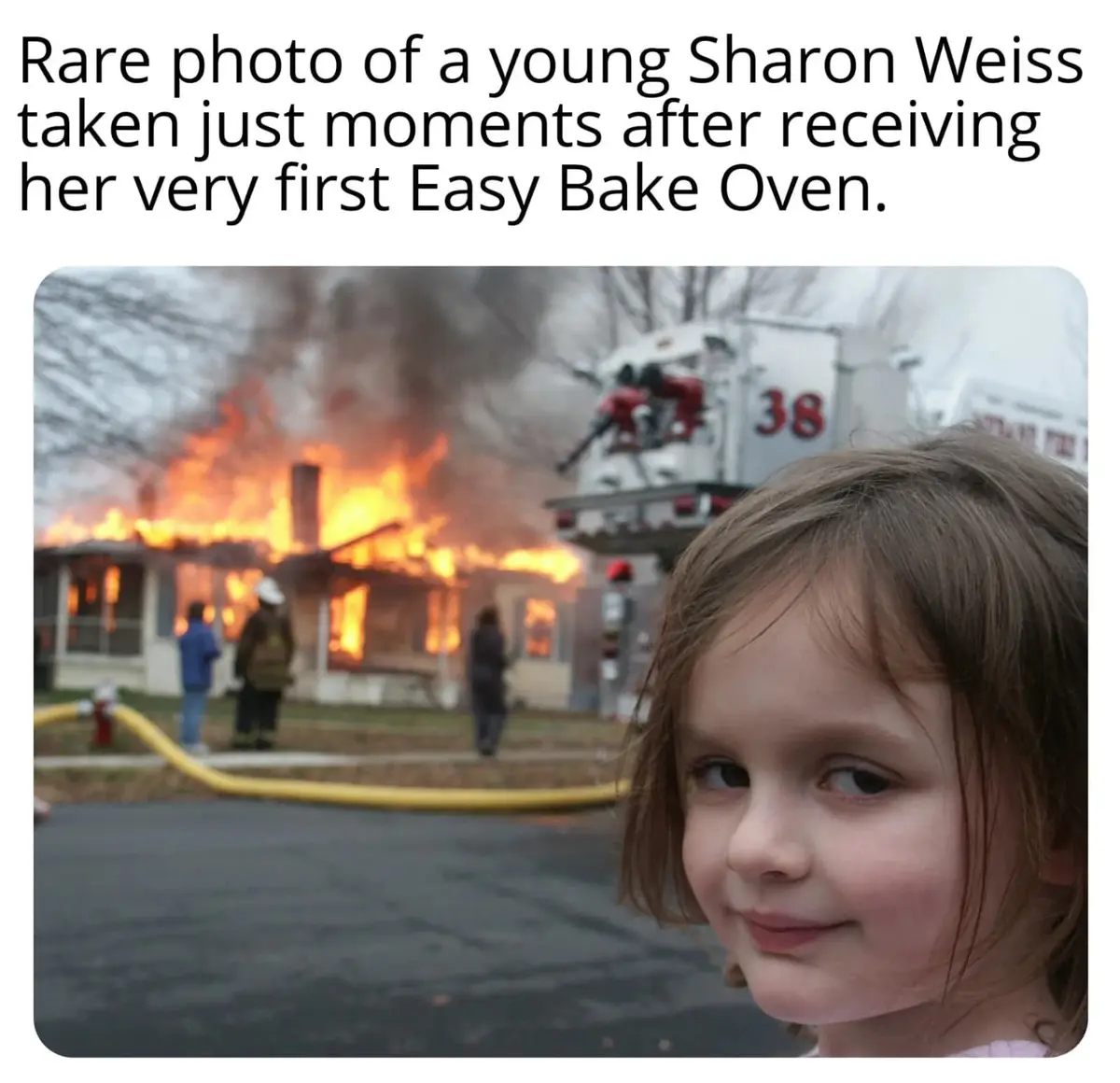 A young girl with a smug, satisfied smile is in the foreground, while behind her, a house is engulfed in flames with…