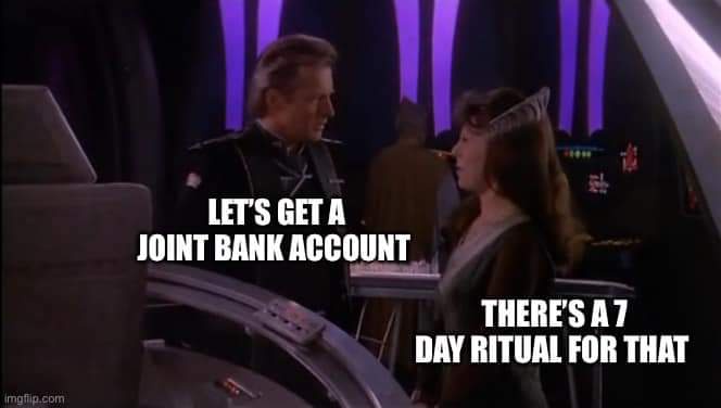 A man and woman in sci-fi uniforms face each other in a spaceship control room. White text overlaid on the image reads…