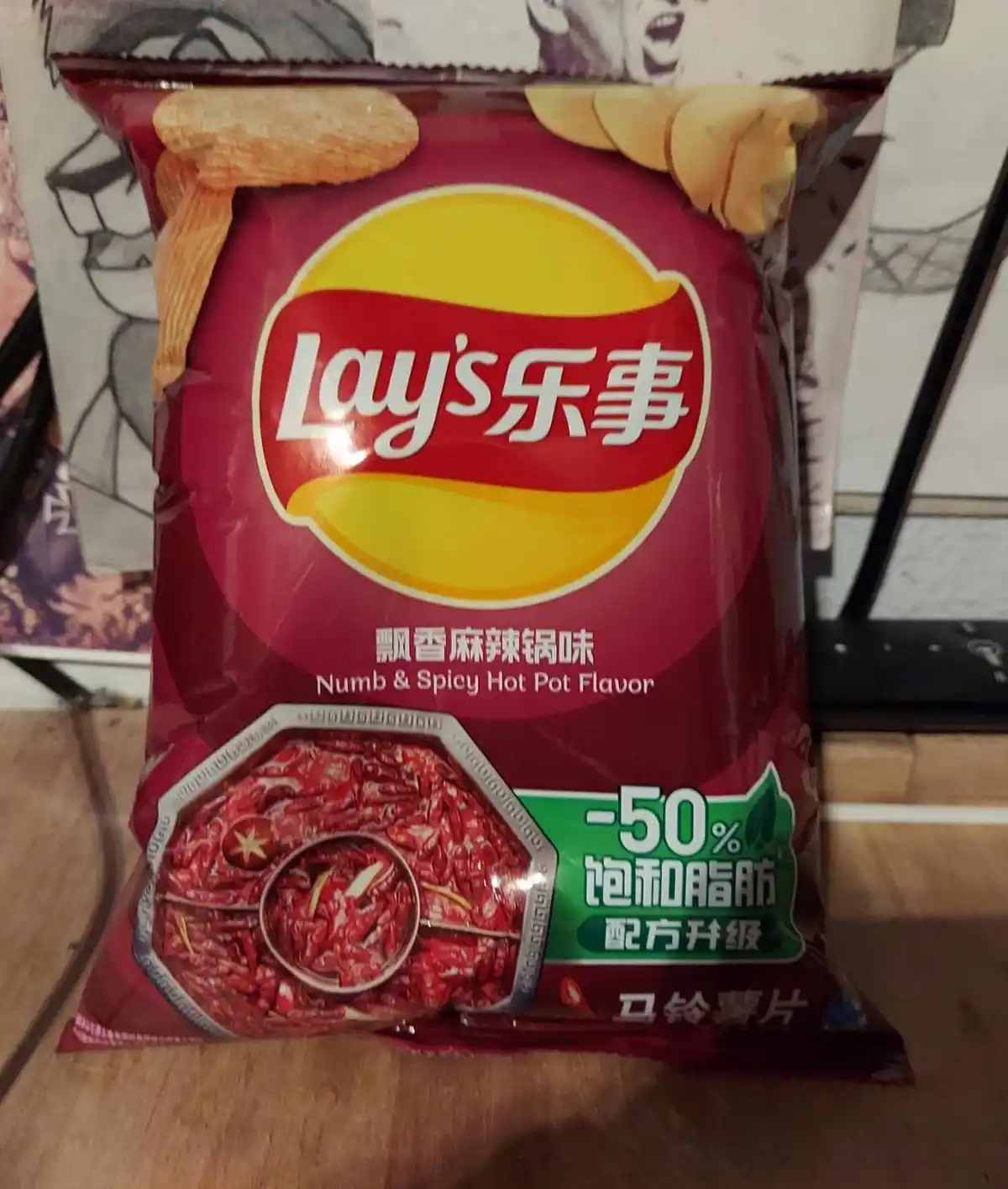 A red bag of Lay's potato chips featuring 'Numb & Spicy Hot Pot Flavor' in both Chinese and English, with an image of chili…