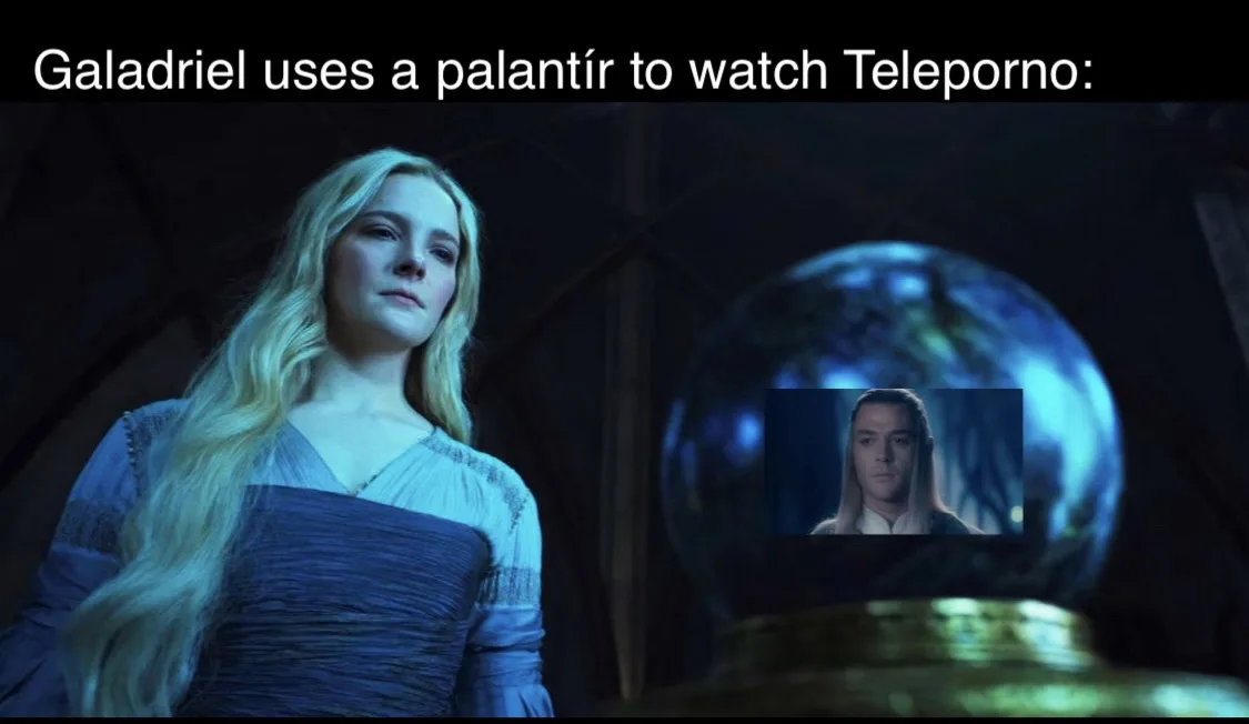 A woman with long blonde hair in a blue dress stands beside a glowing blue orb. Inside the orb, a man with long hair is…