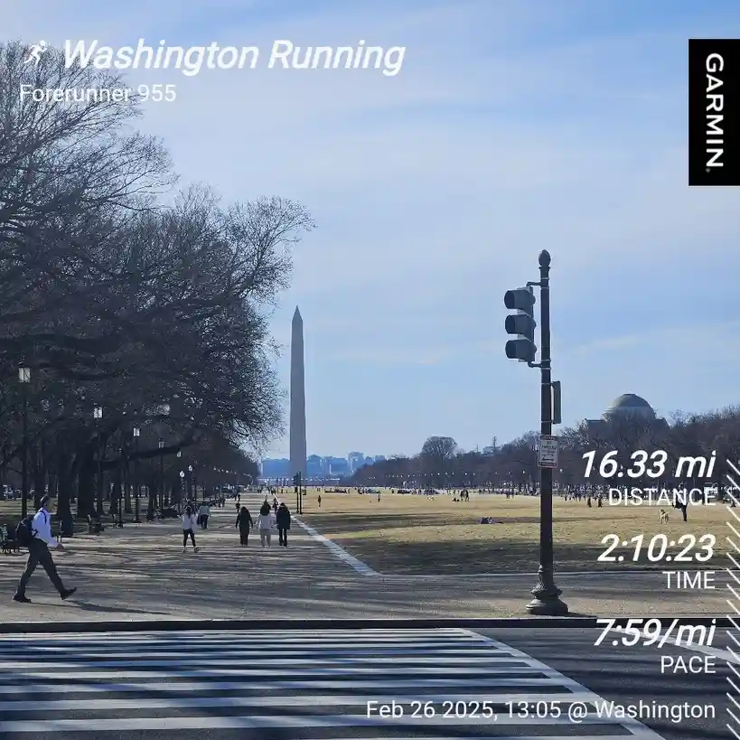 A screenshot of a Garmin Forerunner 955 running app overlay on a photo of the Washington Monument and National Mall. The…