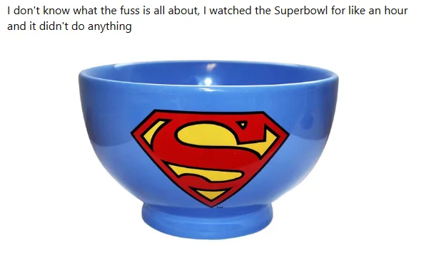 A blue ceramic bowl with the Superman logo prominently displayed on its side. The bowl is photographed against a plain white…
