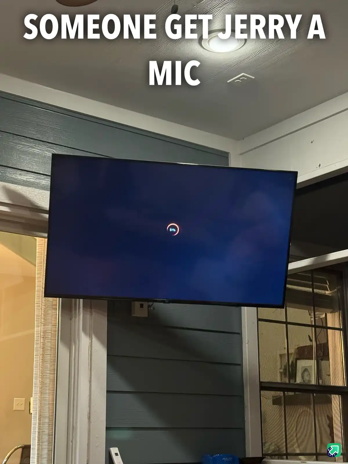 A photo of a TV screen displaying a blue loading screen with a red circular progress bar at 51%. Large white text overlaid…