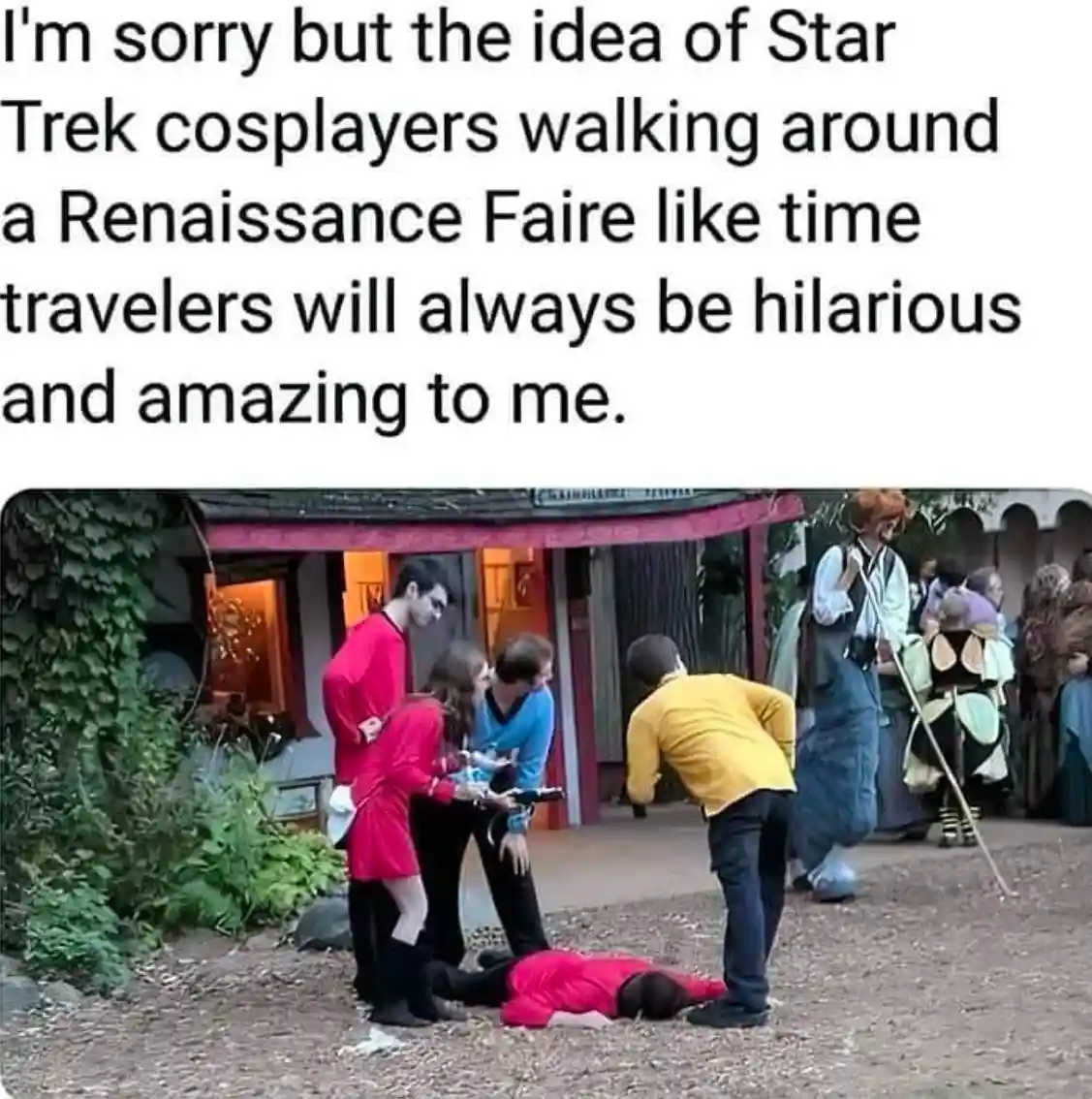 A group of people dressed as Star Trek characters are gathered at a Renaissance Faire. One person in a red uniform lies on…