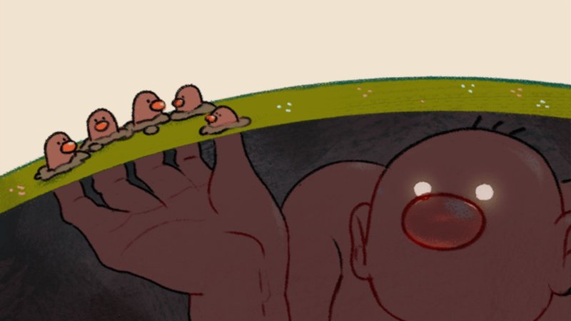 A cartoon image shows a large, bald, wide-eyed baby with a red mouth, emerging from a dark hole in the ground. Above the…