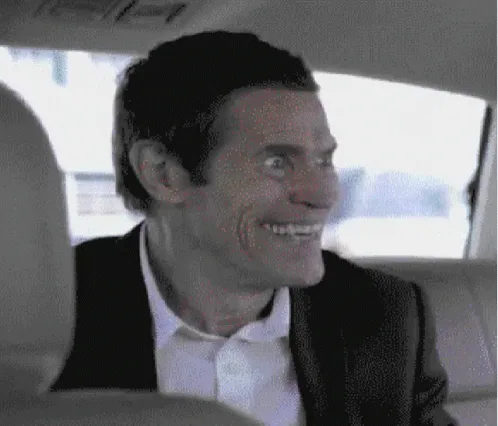 six panels show actor Willem Dafoe in a car, his expression escalating from a wide grin to an increasingly manic, toothy…